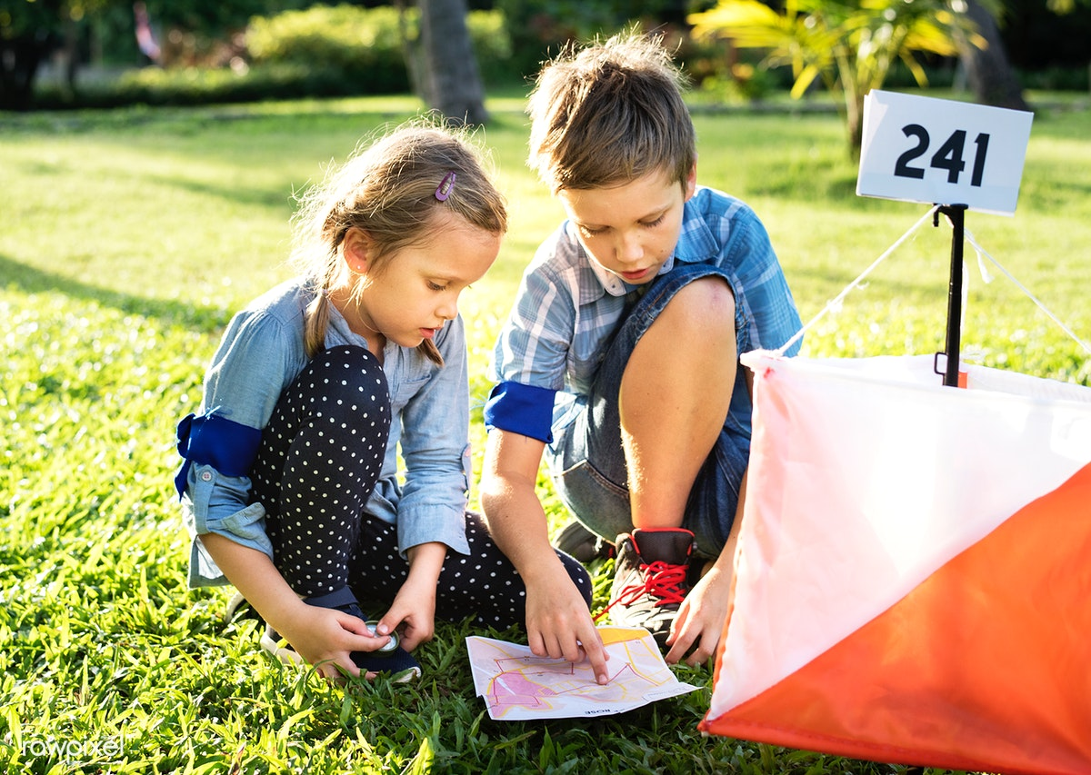 Two children reading a map
